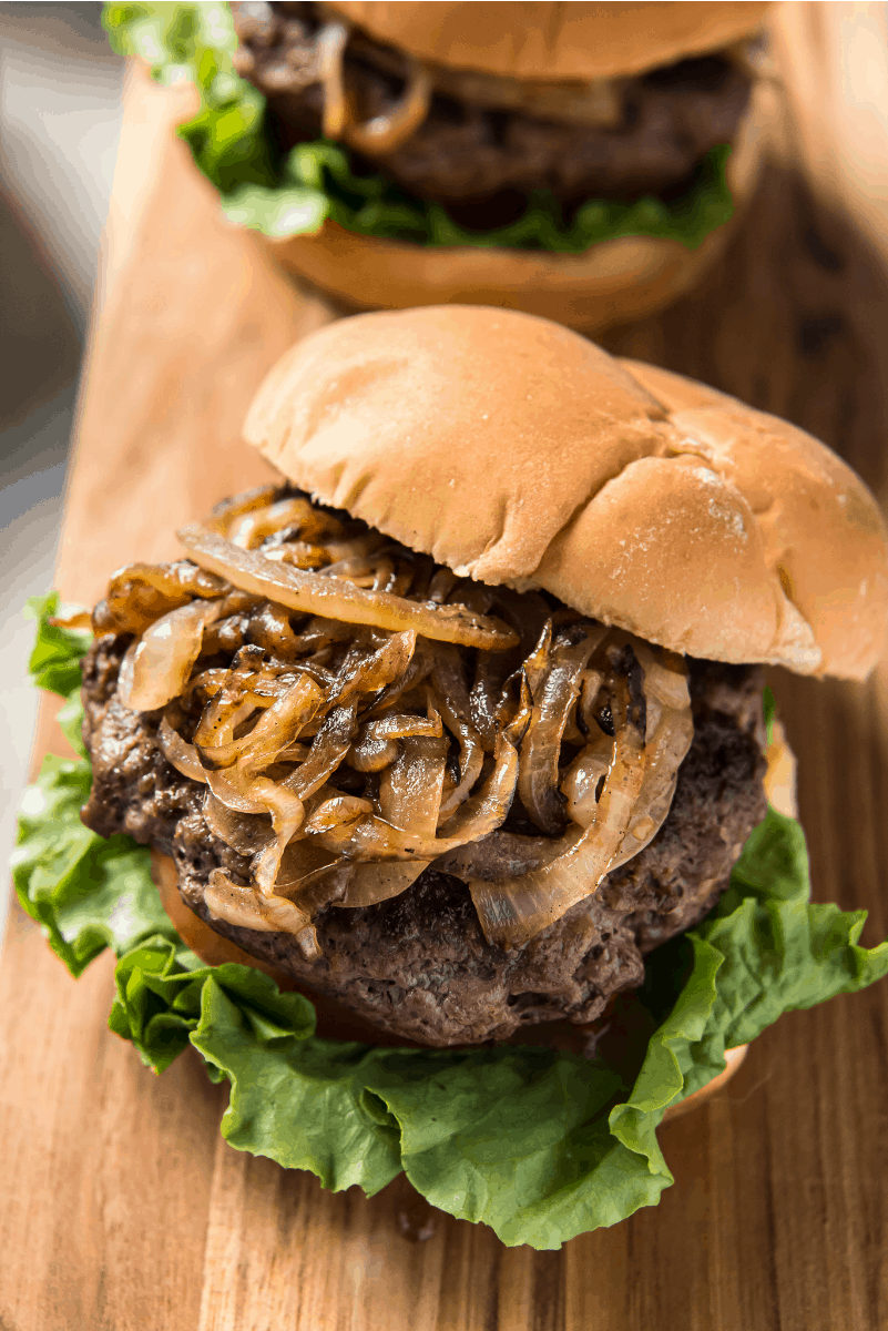 Jucy Lucy Burgers recipe from RecipeGirl.com #jucy #juicy #lucy #burger #burgers #minneapolis #copycat #recipe #RecipeGirl jucy lucy burger with lettuce and tomato and grilled onions piled high